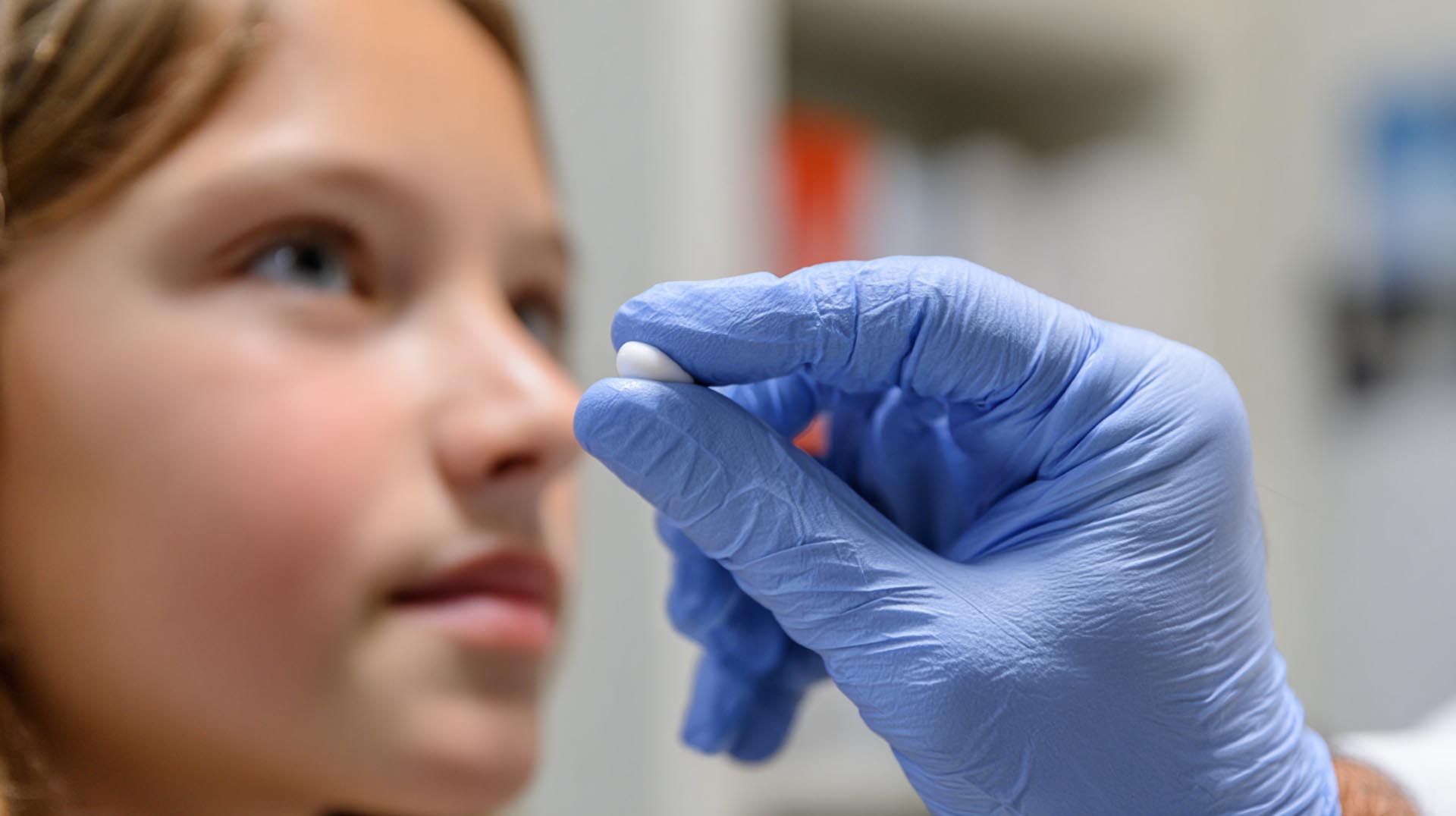 A provider demonstrates the correct amount of topical retinoid cream to a patient, a key patient education topic in the Treating Acne CE Nursing course.