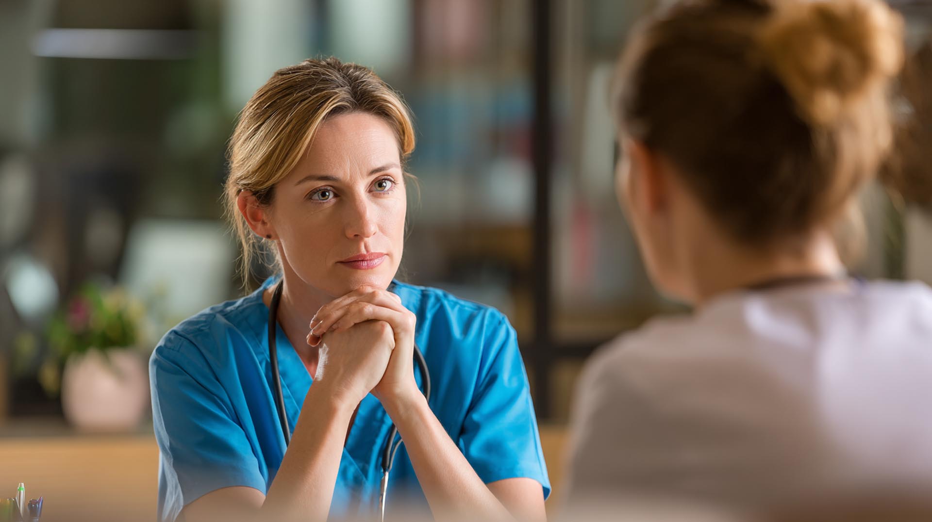 A nurse manager and staff nurse have a supportive debriefing, illustrating the Just Culture principles taught in the medical errors CE Nursing course.
