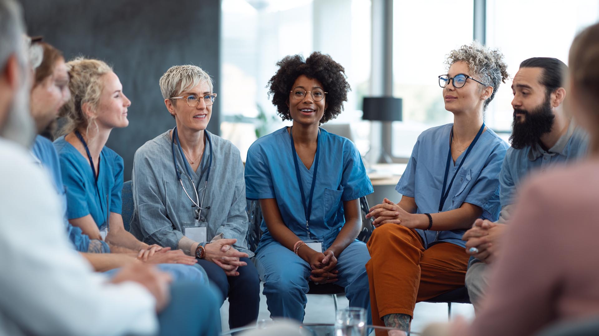 A group of nurses discusses professional wellbeing, a key topic included in the comprehensive South Carolina CE Nursing course bundle.